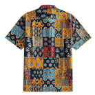 OROMEN Ajrakh Mosaic Hawaiian shirt back flat lay showing full allover patchwork block layout with paisley, sun circles, folk birds and botanical motifs in navy, amber, slate blue and burgundy
