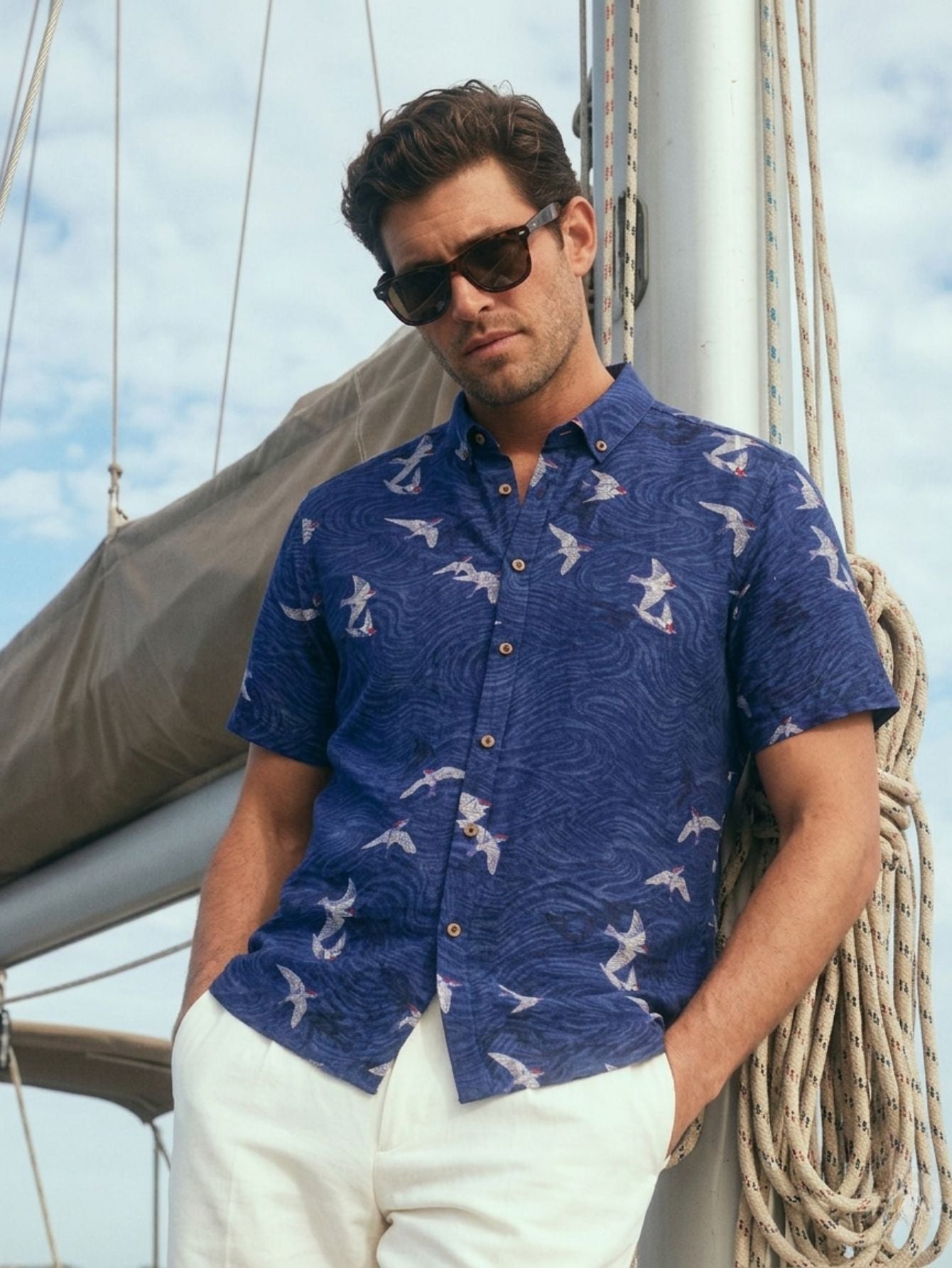 OROMEN Arctic Tern Print Shirt – Model view; features an all-over dark blue seabird pattern and a button-down collar.