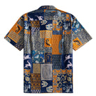 OROMEN Aviary Patchwork Hawaiian shirt back flat lay showing full patchwork block layout with peacocks, leaping deer, folk birds and fern panels in navy blue and amber orange