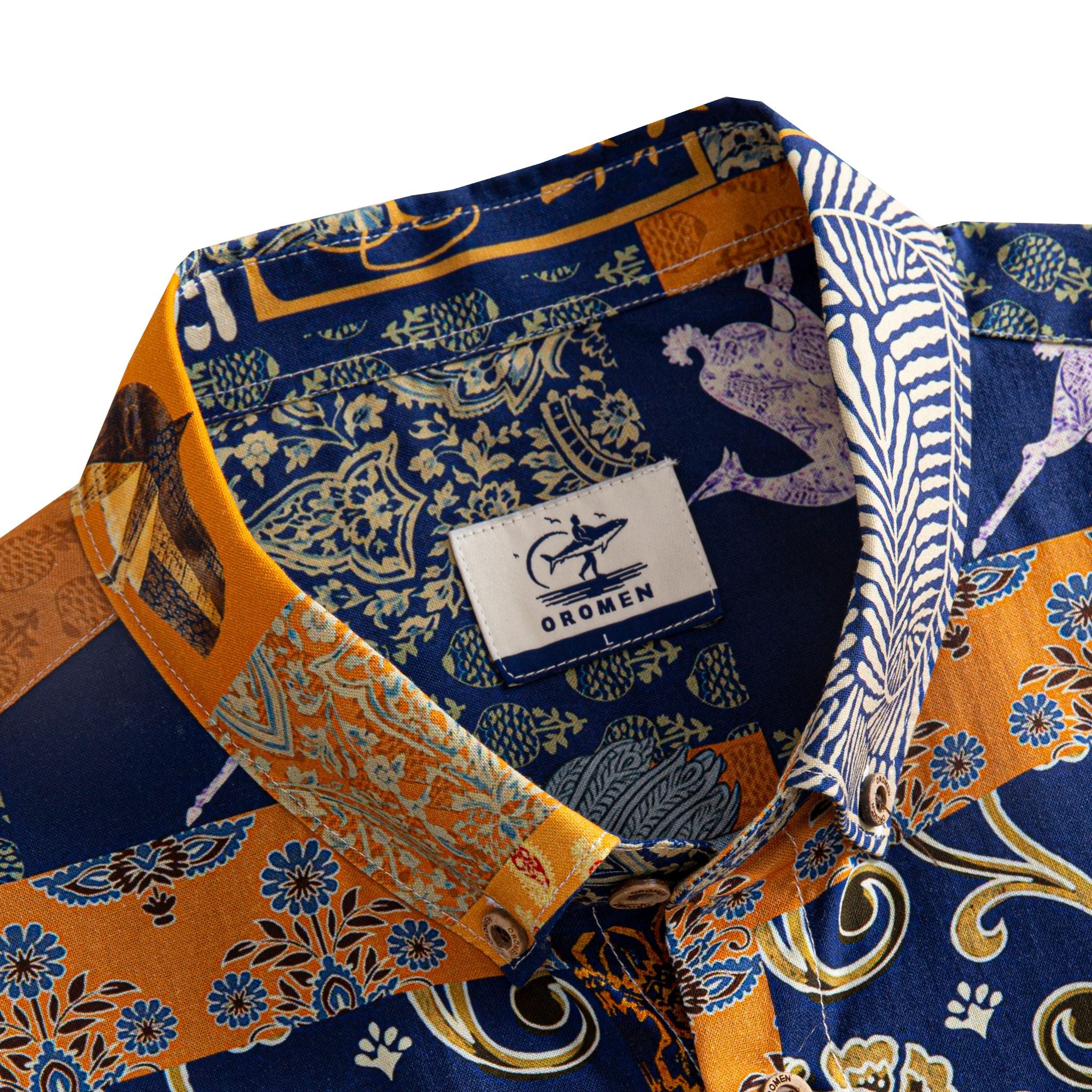 OROMEN Aviary Patchwork shirt button-down collar detail showing OROMEN branded label and peacock floral patchwork panels in navy blue and amber orange
