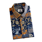 OROMEN Aviary Patchwork shirt folded display showing OROMEN branded label, coconut buttons and navy blue amber orange multi-motif patchwork print