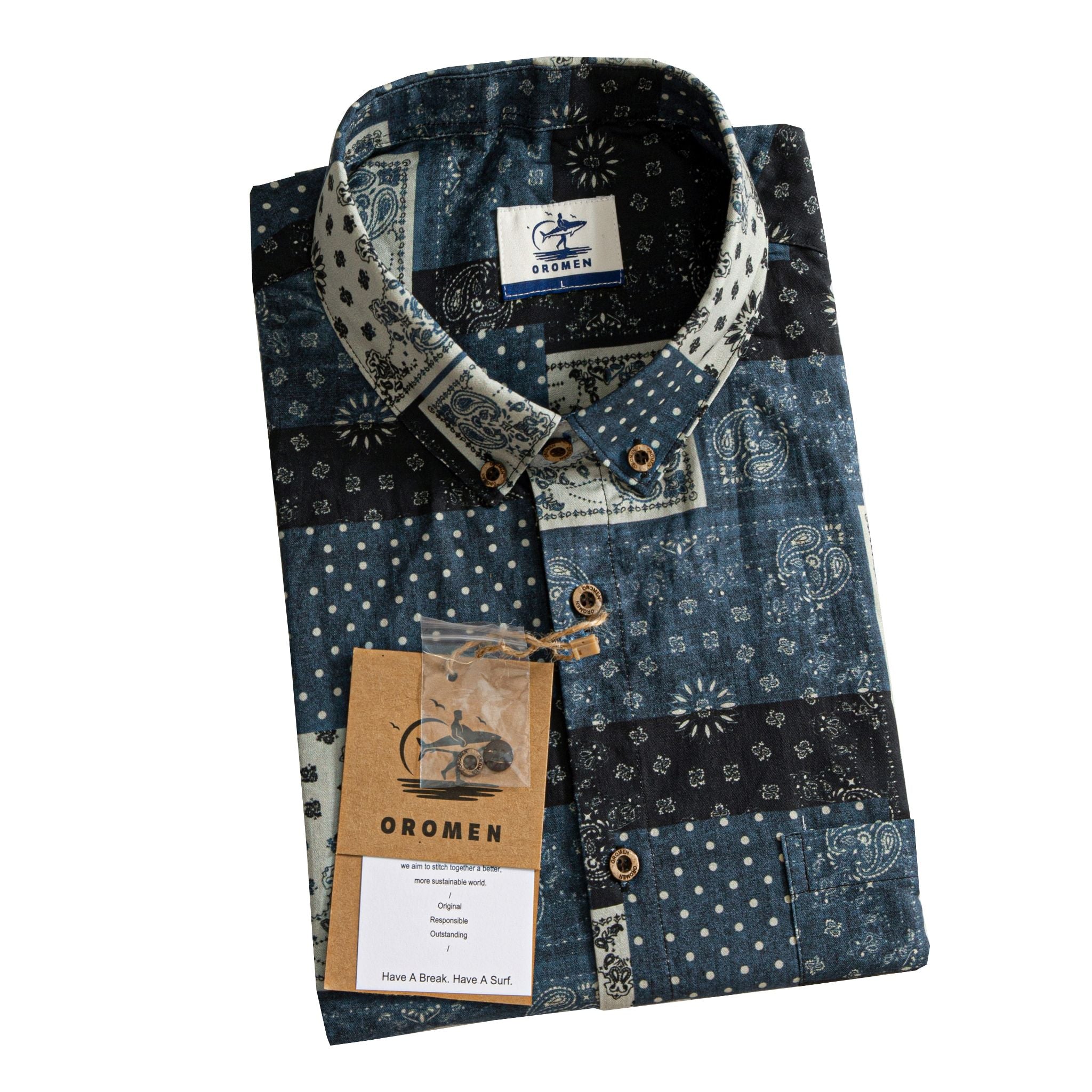 OROMEN Bandana Patchwork shirt folded with branded tag and coconut buttons, indigo black off-white paisley patchwork