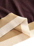 OROMEN Casa Mocha Knit Polo hem detail showing structured ribbed trim with contrast color blocking