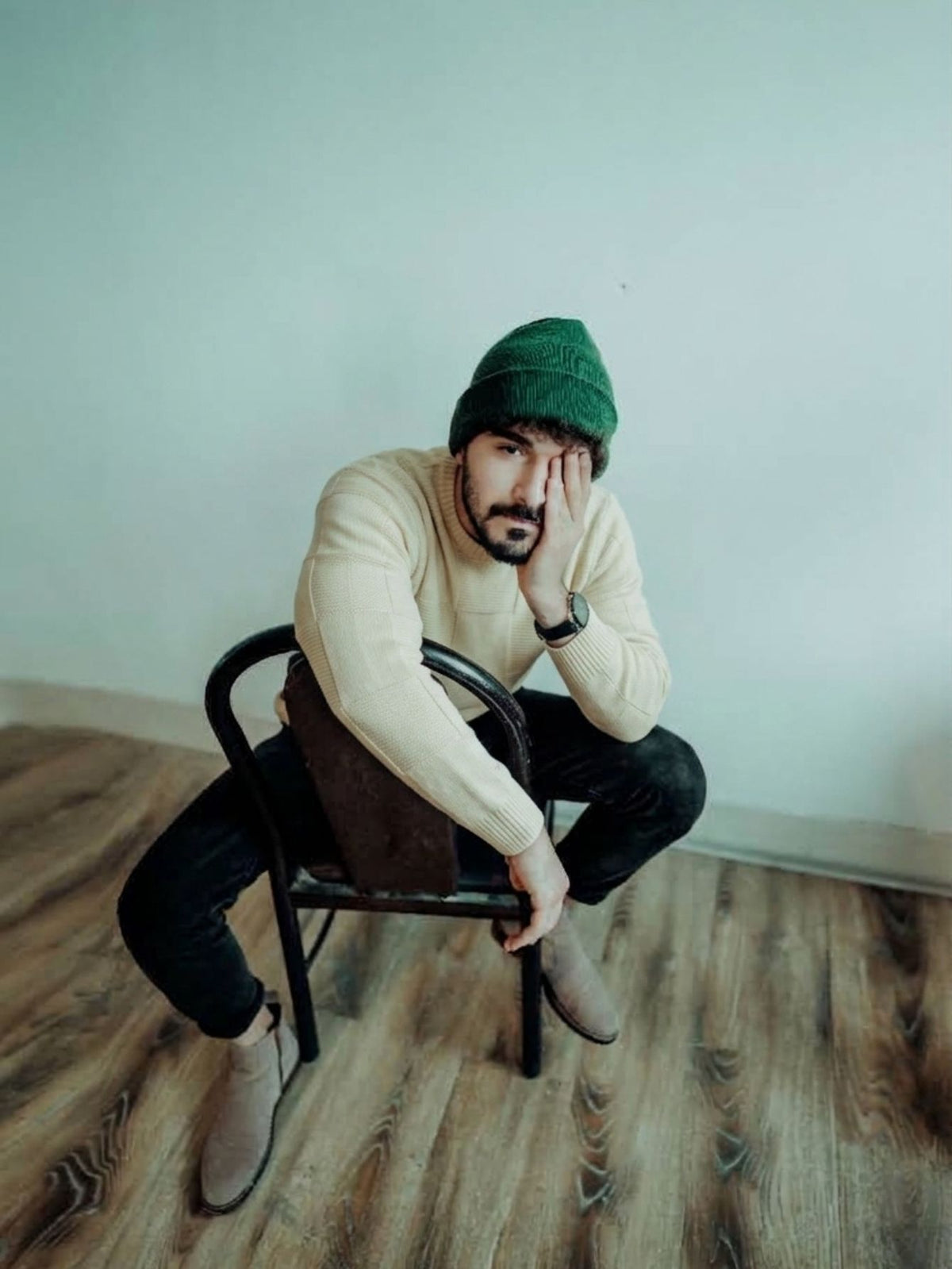 OROMEN Checkerboard Textured Sweater cream male model seated studio lifestyle shot