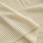 OROMEN Checkerboard Textured Sweater cream ribbed hem detail close-up