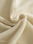 OROMEN Checkerboard Textured Sweater fabric detail highlighting textured checkerboard weave
