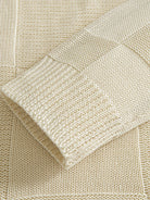 OROMEN Checkerboard Textured Sweater sleeve cuff detail showing structured ribbed knit finish