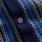 OROMEN Herringbone Jacquard Knit Polo navy blue mother-of-pearl button placket close-up