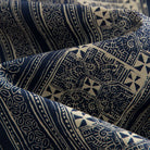 OROMEN Indigo Batik shirt fabric close-up, eight-pointed star and spiral motifs in navy and off-white cotton