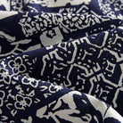 OROMEN Indigo Katazome shirt fabric close-up, navy blue and off-white patchwork texture