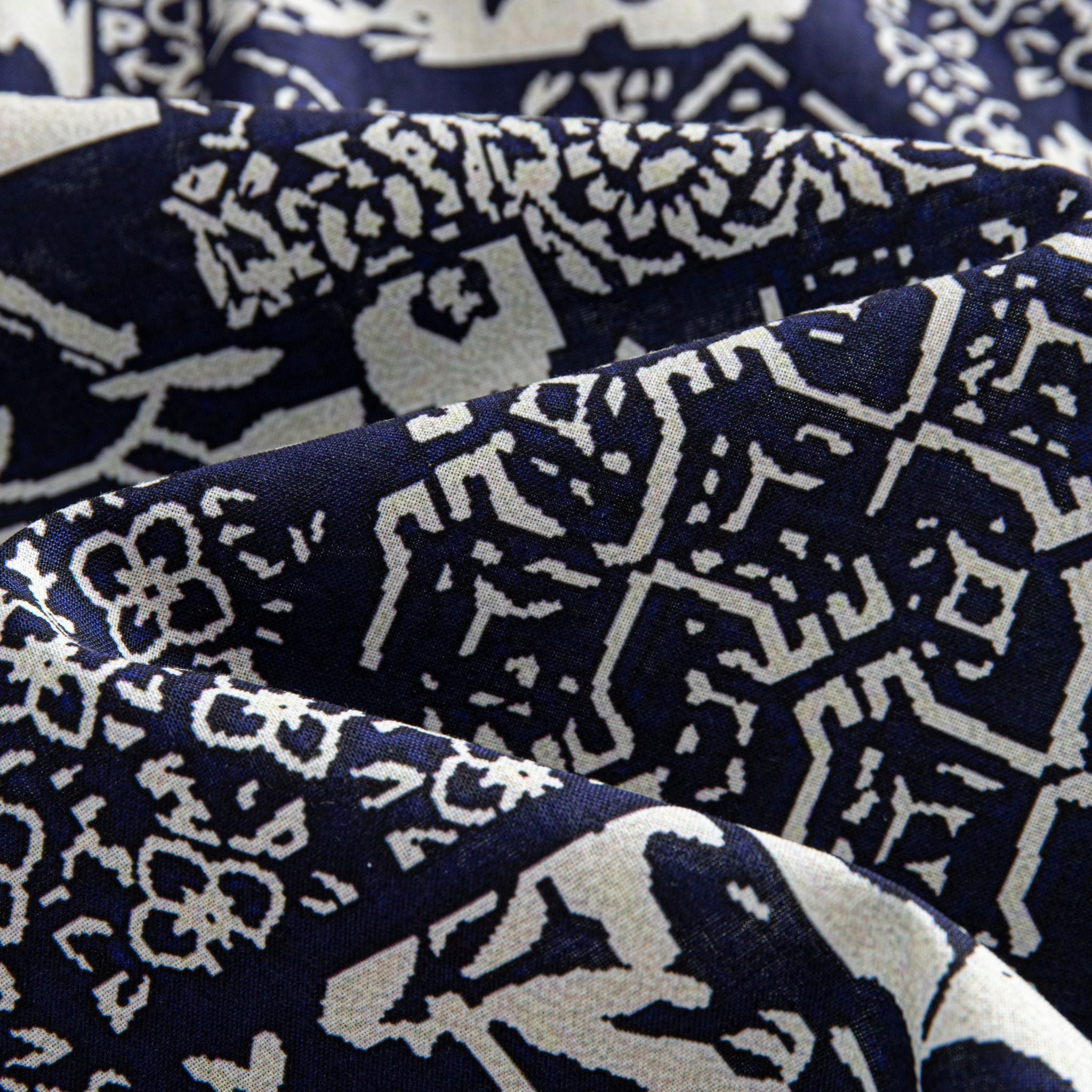 OROMEN Indigo Katazome shirt fabric close-up, navy blue and off-white patchwork texture