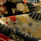 OROMEN Kiku & Fan shirt – draped fabric detail showing contrast between black ground and gold fan panels with kiku blooms red peonies and bamboo leaf motifs