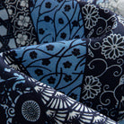 OROMEN Komon Patchwork shirt fabric close-up, karakusa vine, fan and floral patchwork in navy and sky blue cotton