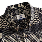 OROMEN Noir Patchwork shirt button-down collar detail showing OROMEN branded label and multi-motif monochrome patchwork panels in black and off-white