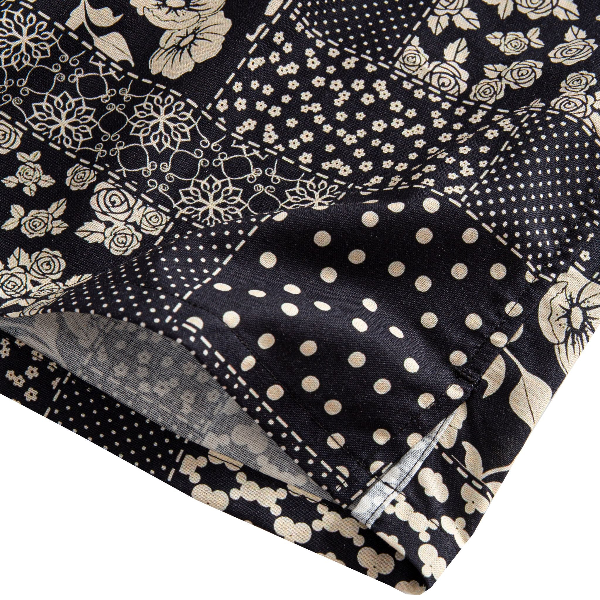 OROMEN Noir Patchwork shirt side vent detail showing polka dot, snowflake geometric and floral patchwork blocks with double needle stitching in black and off-white