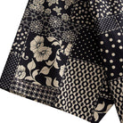 OROMEN Noir Patchwork shirt sleeve detail showing rose, polka dot and geometric patchwork motifs in black and off-white 100% cotton