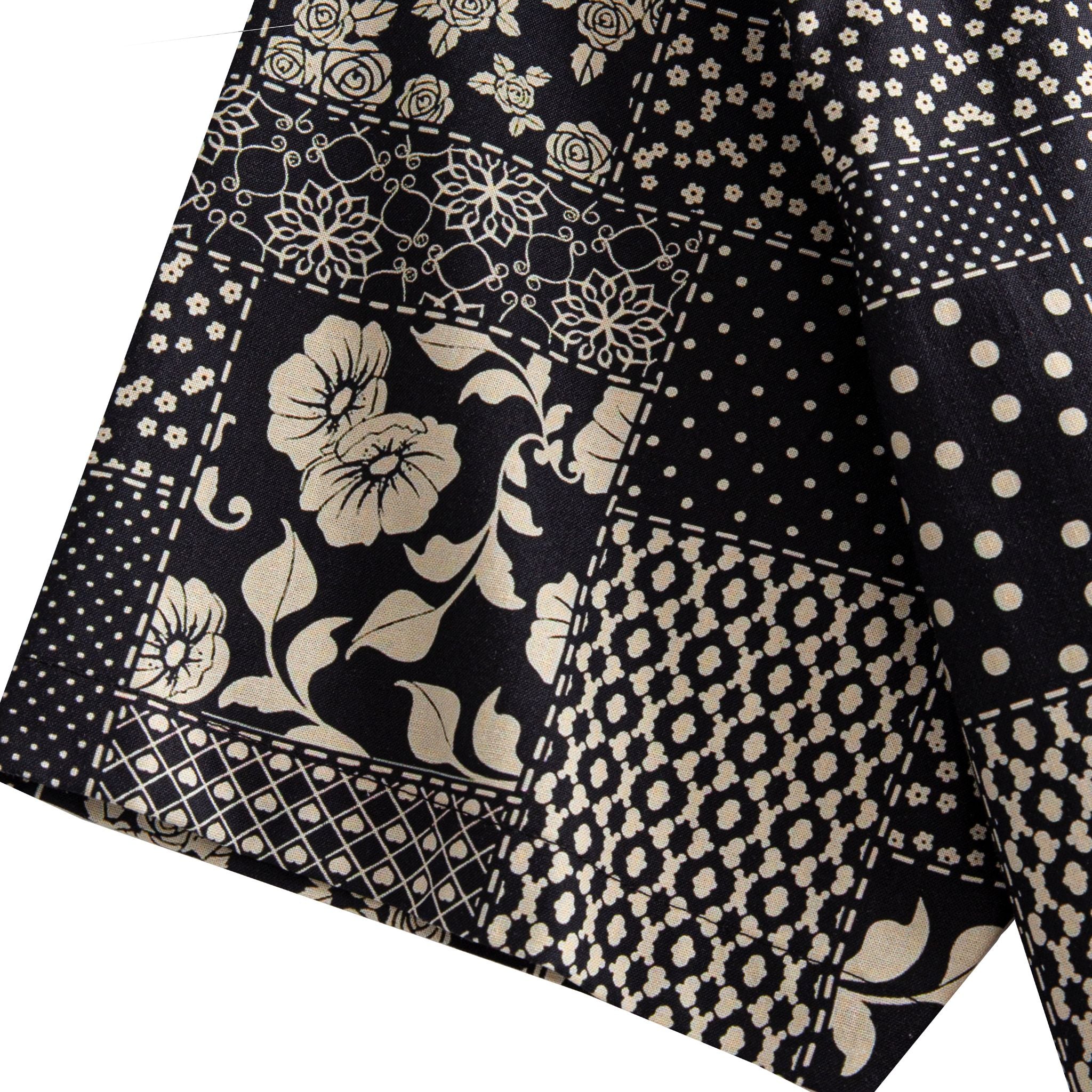 OROMEN Noir Patchwork shirt sleeve detail showing rose, polka dot and geometric patchwork motifs in black and off-white 100% cotton
