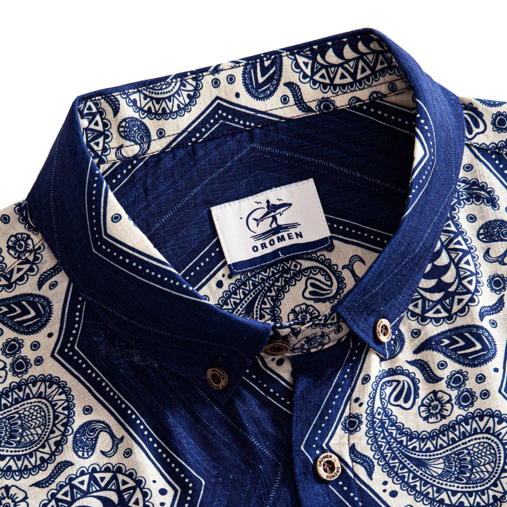 OROMEN Paisley Bandana shirt button-down collar detail showing branded label and intricate navy paisley print on off-white ground