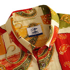 OROMEN Rajasthan Paisley shirt button-down collar detail showing OROMEN branded label and multi-color paisley patchwork panels in crimson, amber and olive