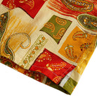 OROMEN Rajasthan Paisley shirt side vent detail showing multi-color paisley patchwork blocks in crimson, amber, olive and cream with double needle stitching