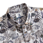 OROMEN Reef Atlas Hawaiian shirt – brand label and engraved coconut buttons detail on marine naturalist print collar