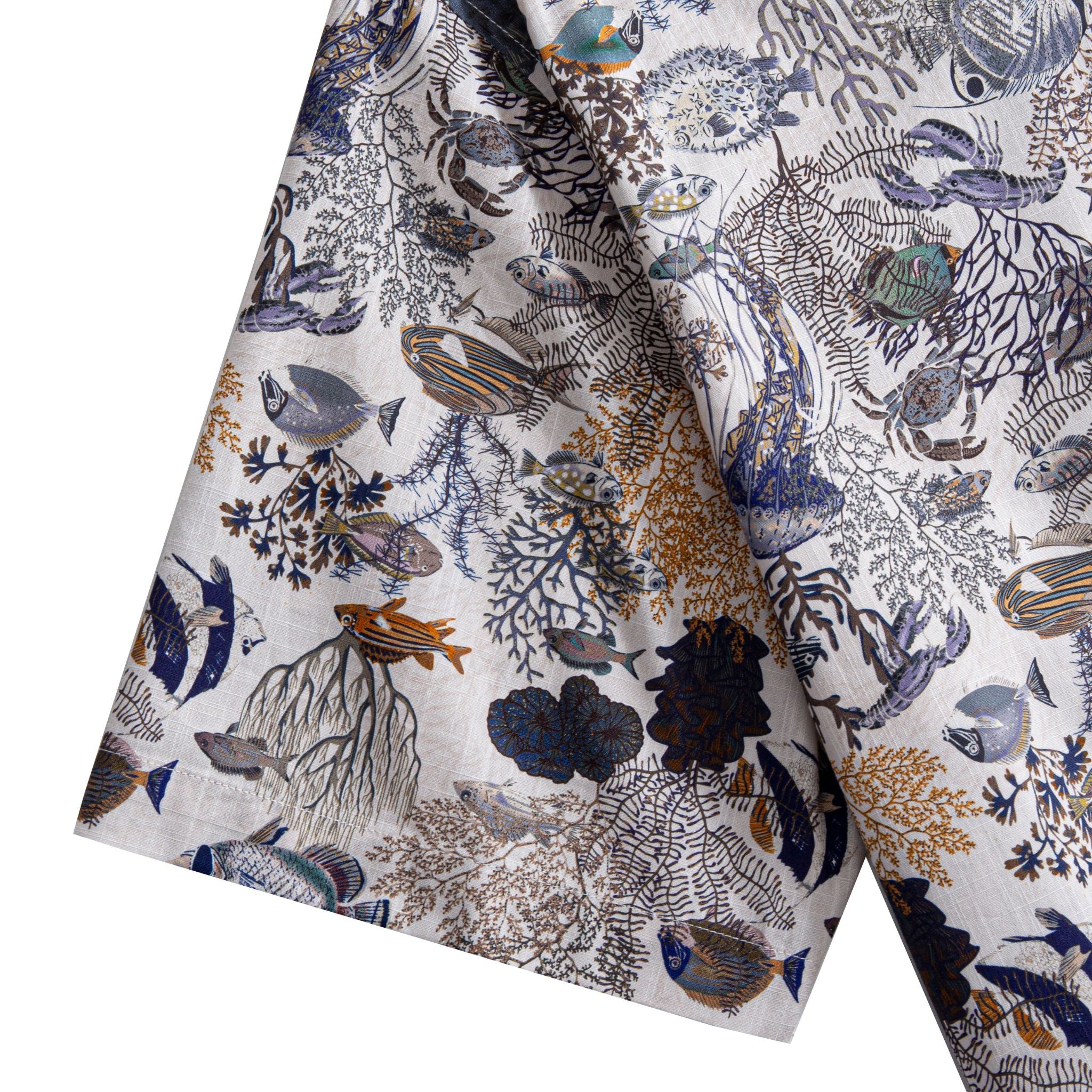 OROMEN Reef Atlas Hawaiian shirt – short sleeve hem with tropical fish and coral branch print on white cotton