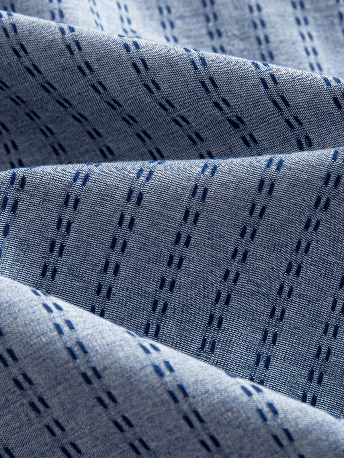 OROMEN Sashiko Chambray Cotton Shirt fabric detail highlighting navy sashiko stitching on chambray
