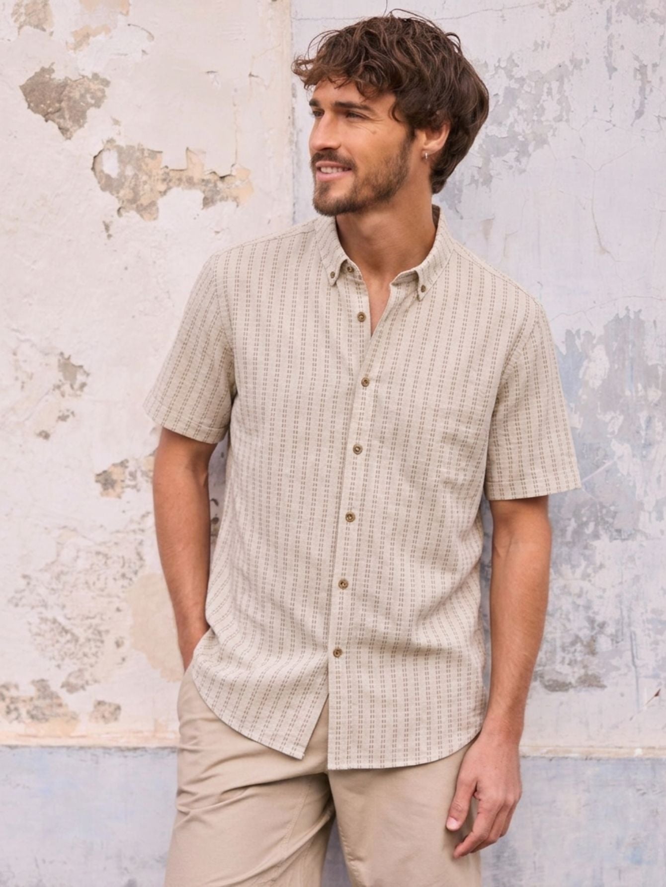 OROMEN Sashiko Natural shirt model image, oatmeal-colored cotton fabric adorned with all-over tan Sashiko embroidered stripes.