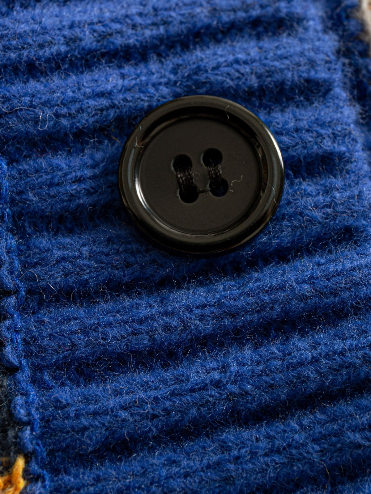 OROMEN Striped Swirl Jacquard Knit Cardigan button placket detail with contrast black buttons