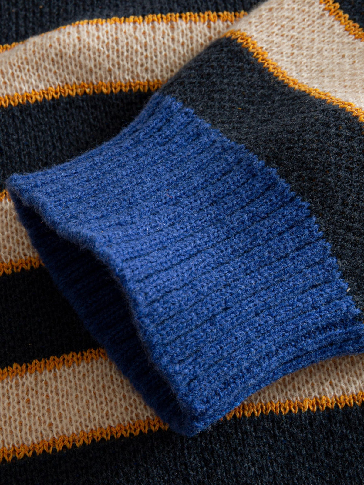 OROMEN Striped Swirl Jacquard Knit Cardigan sleeve cuff detail showing structured blue ribbed trim