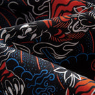 OROMEN Tiger Wave shirt – draped fabric detail showing layered red tiger blue wave and white cloud motifs on black cotton highlighting fabric texture and print depth