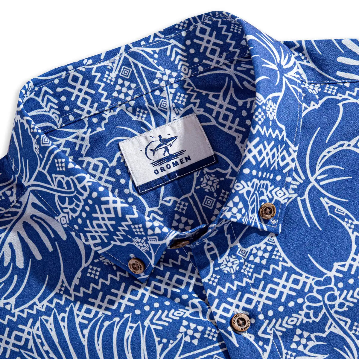 OROMEN brand label and engraved coconut buttons detail on Plant Totem Hawaiian shirt collar