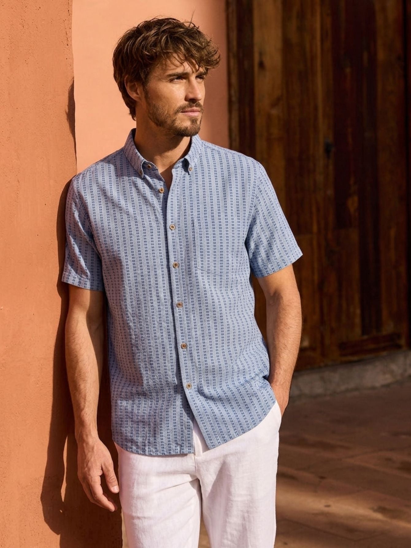 OROMEN light blue sashiko embroidered shirt model image. The light blue washed fabric is decorated with a navy blue sashiko pattern.