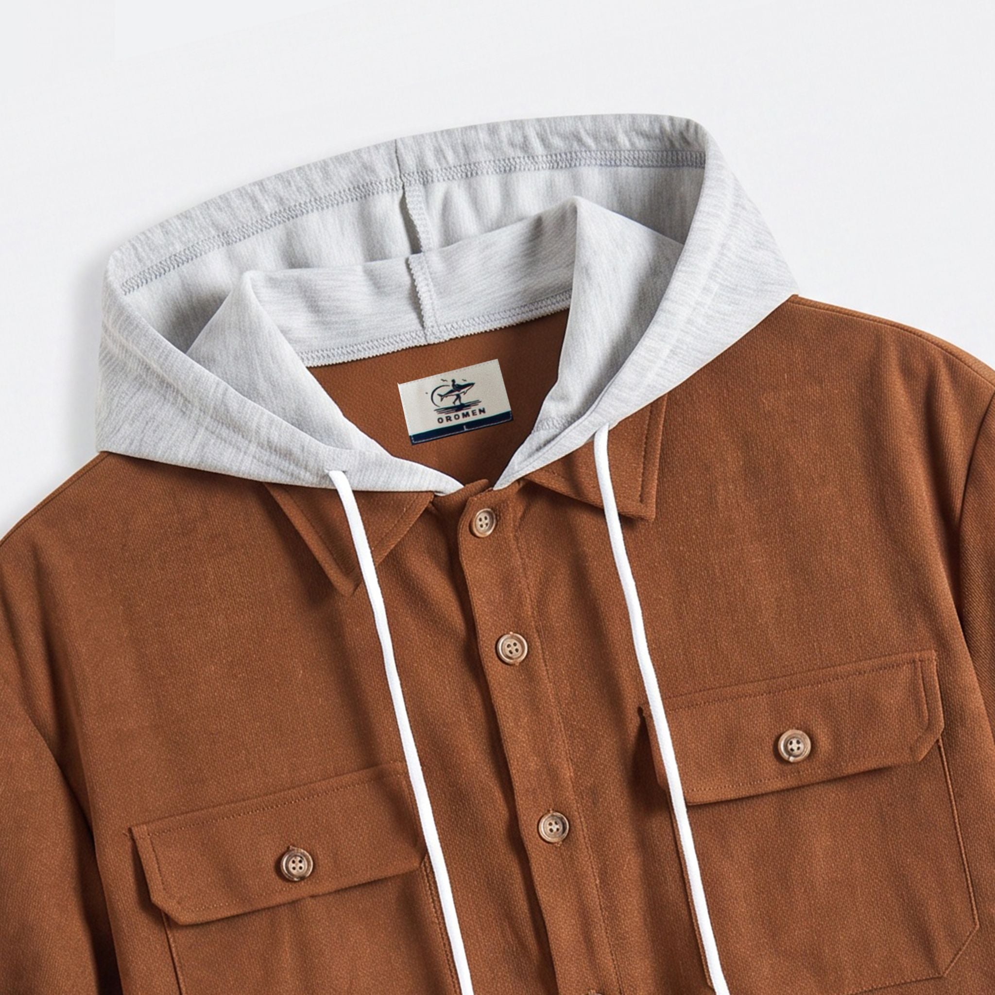 OROMEN brand label and heather grey hood close-up on rust brown hooded shirt