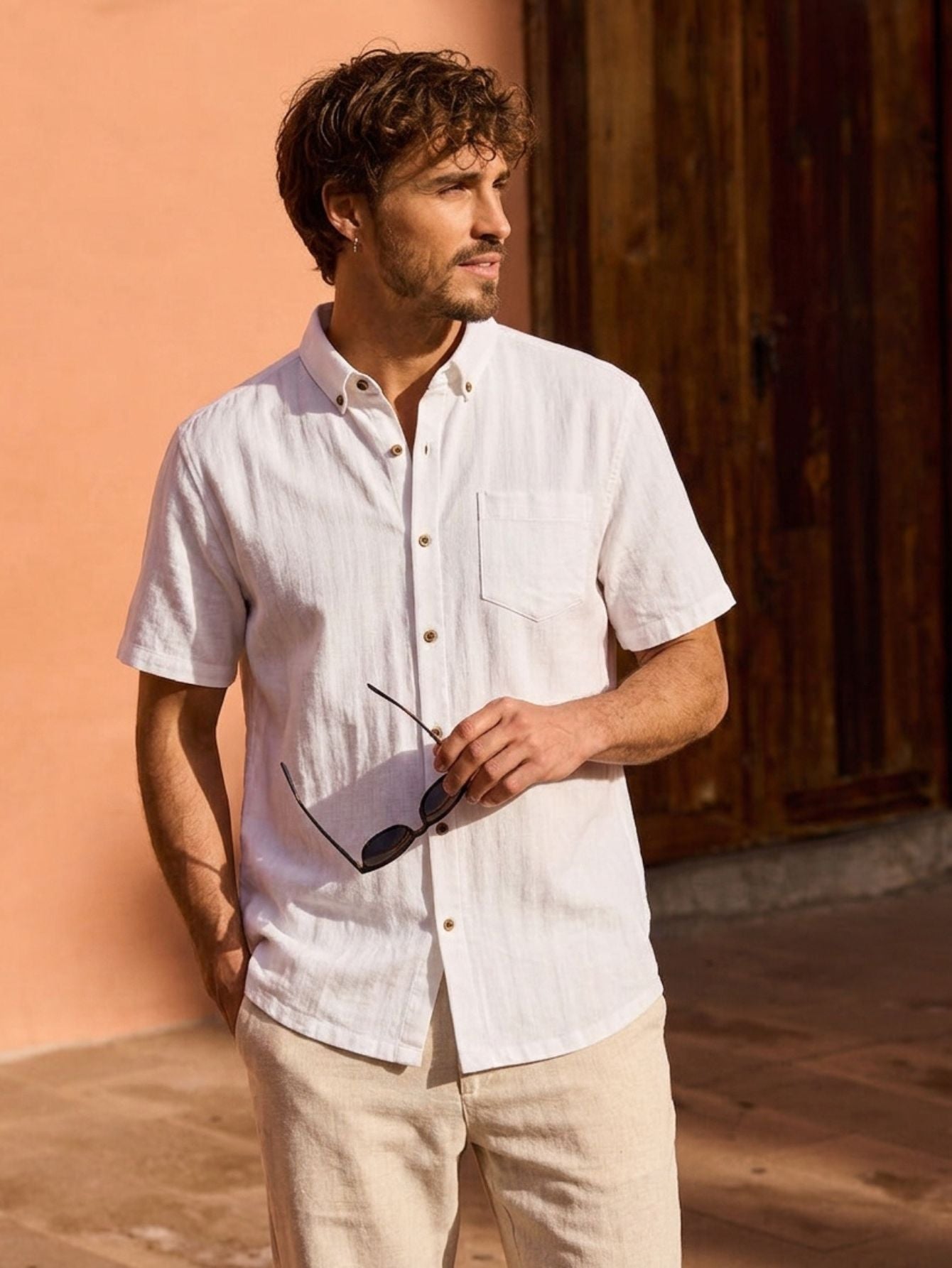 OROMEN textured stripe shirt – shown on a model. Crafted from a white Tencel™ and linen blend, it features subtle tonal stripes and coconut shell buttons.