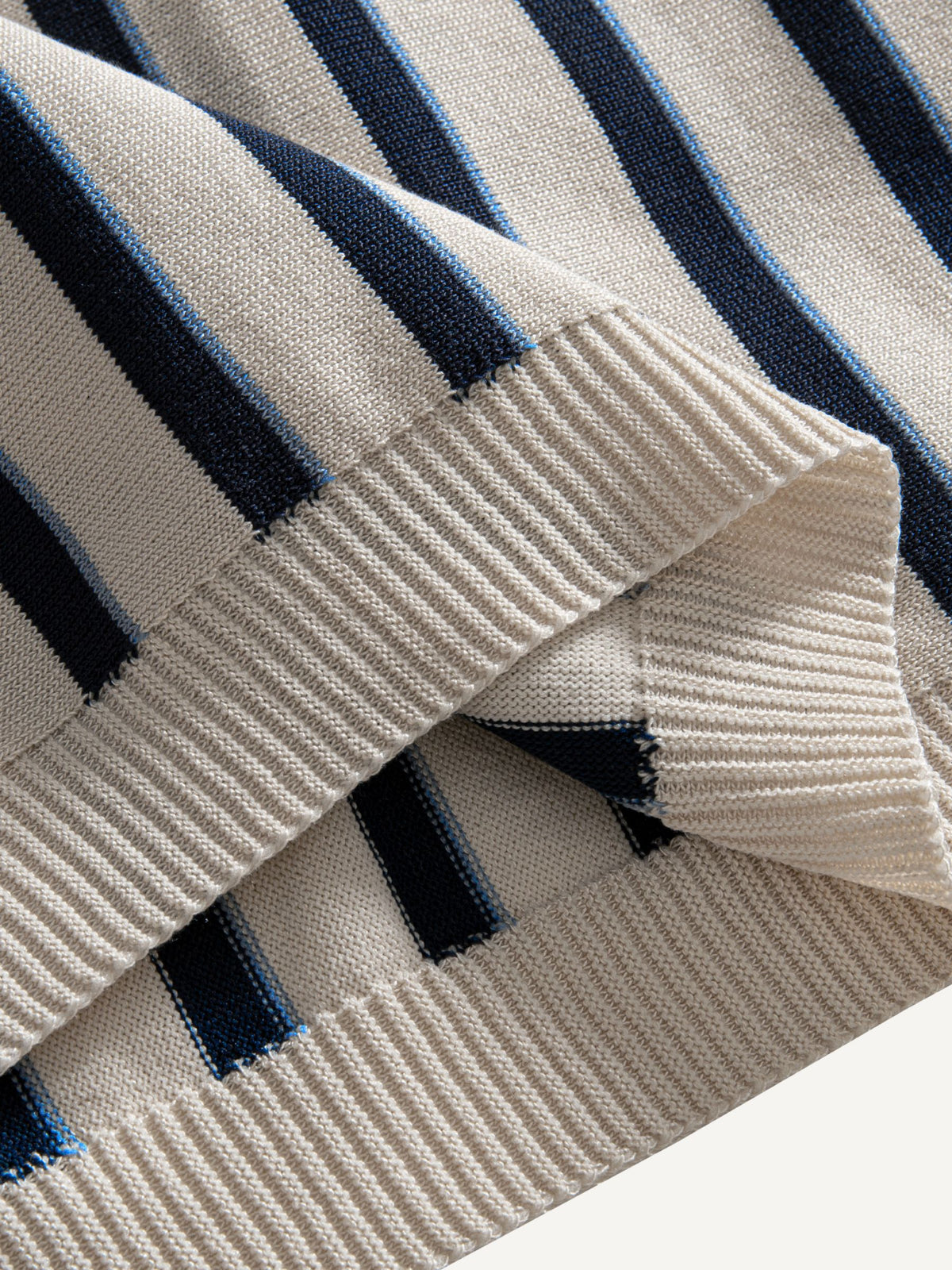 Ribbed bottom hem detail on OROMEN Stripe Knit Open-Collar Polo