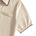 Ribbed cuff detail with dual-tone brown and khaki contrast trim on men's cream knit polo – OROMEN