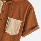 Rolled‑cuff‑detail‑on‑rust‑polyester‑corduroy‑short‑sleeve‑of‑OROMEN‑colorblock‑hooded‑shirt