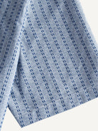 Short sleeve cuff and double-needle stitching detail of OROMEN Sashiko Chambray Cotton Shirt