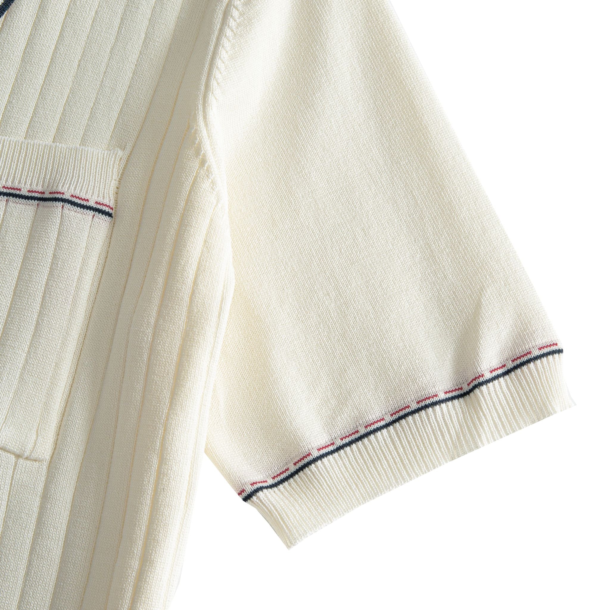 Short sleeve cuff close-up on cream knit polo, navy and rust contrast
stripe tipping, fine ribbed knit edge, clean finish – OROMEN
