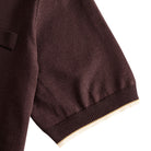 Short sleeve cuff close-up with off-white contrast ribbed tipping,
chocolate brown viscose knit polo shirt – OROMEN