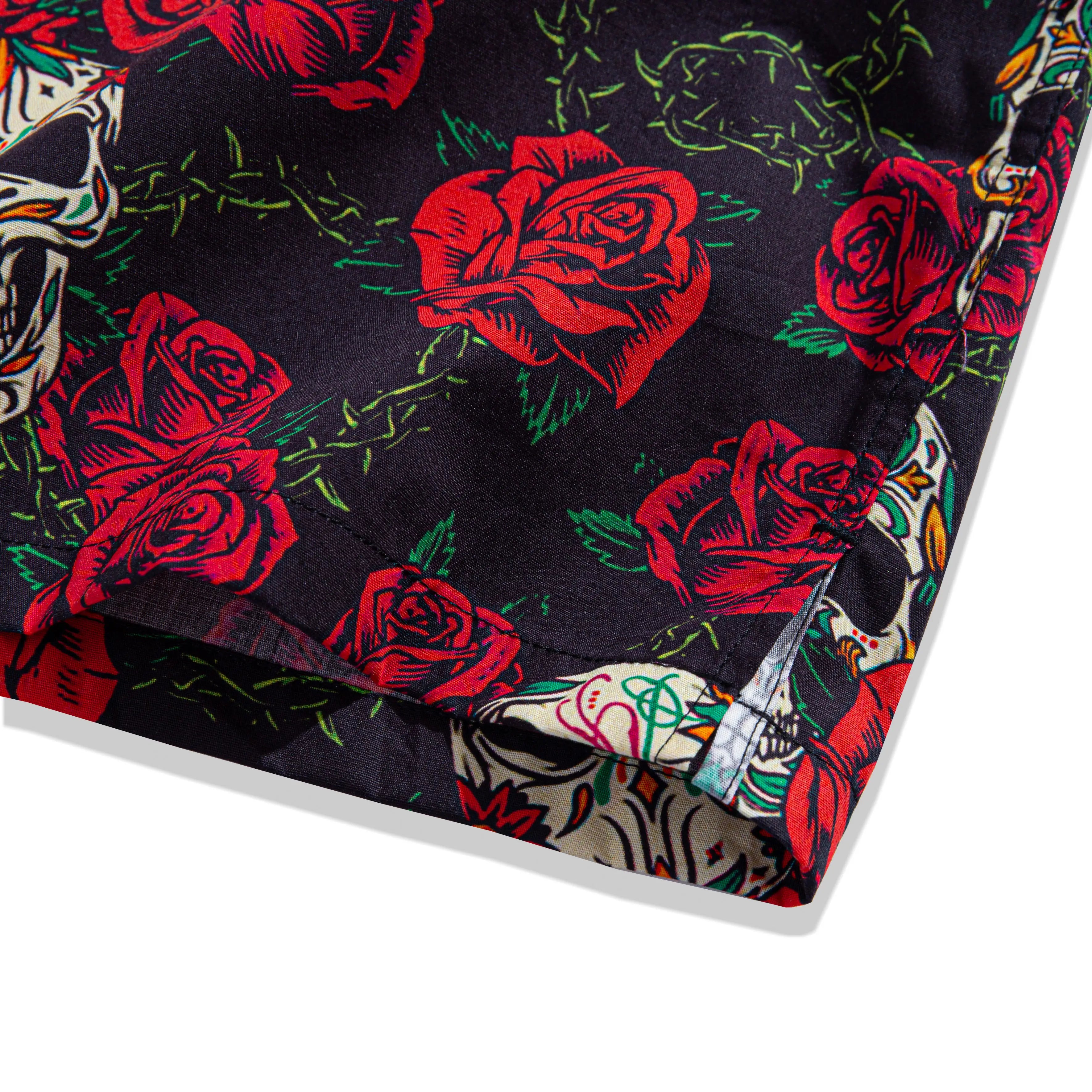 Side vent detail of OROMEN Bloom And Death Hawaiian shirt – relaxed fit hem with sugar skull and rose print