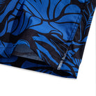 Side vent detail of OROMEN Blue Bush Hawaiian shirt – relaxed fit hem with tropical print