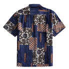 Silk Road Patchwork Hawaiian shirt back flat lay showing full patchwork block layout with indigo ikat stripes, dark brown florals and ethnic geometric squares