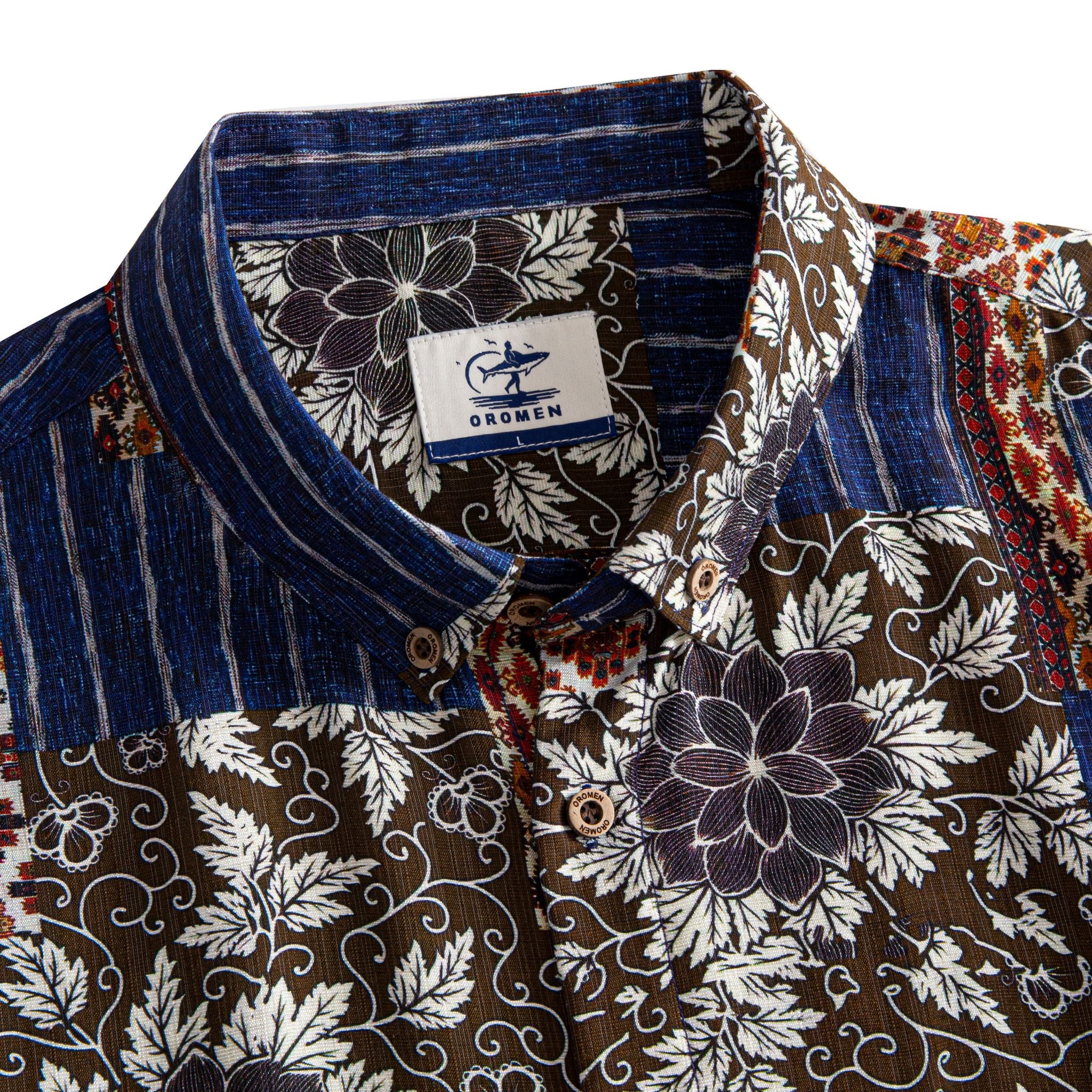 Silk Road Patchwork shirt collar detail showing OROMEN branded label, coconut buttons and patchwork panels of dark brown floral and indigo ikat stripe