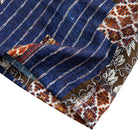Silk Road Patchwork shirt hem and side vent detail showing indigo stripe body with ethnic geometric hem border and dark floral panel
