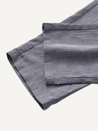 Tapered leg and pre-rolled cuff detail of OROMEN Pleated Relaxed Fit Linen Trousers