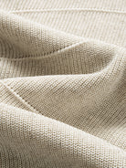 Texture detail of breathable lyocell-linen blend knit with horizontal textured stripes in oatmeal mélange