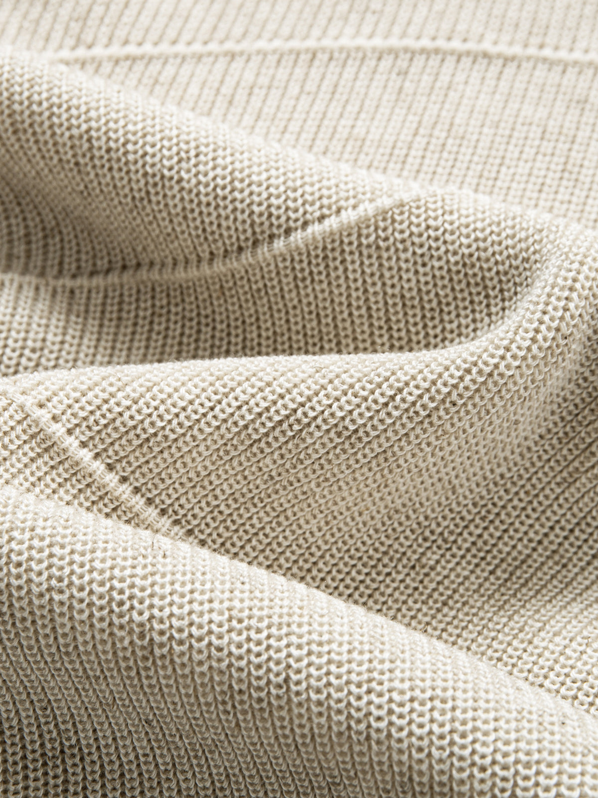 Texture detail of breathable lyocell-linen blend knit with horizontal textured stripes in oatmeal mélange