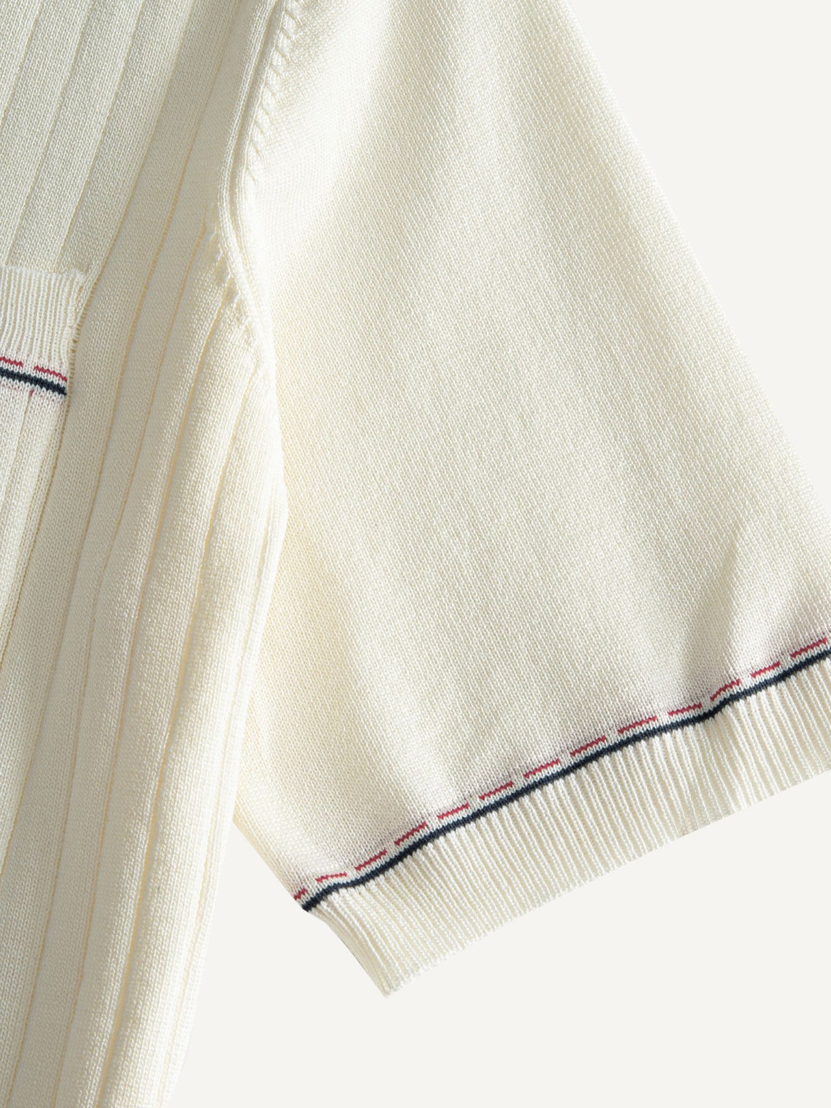 Tri-color tipped sleeve cuff detail on OROMEN Cream Court Knit Polo